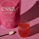 Essa World Collagen poured in a glass in front of a pink background.