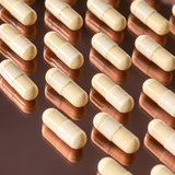 Several Inner Beauty Vitamin pills in a symmetrical setting.